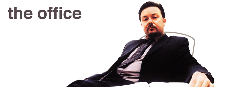 Iconic photo of David Brent (Ricky Gervais) sat at desk