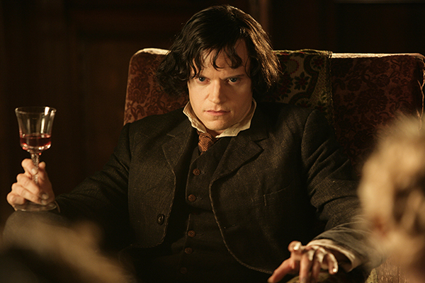 Count Dracula (Marc Warren) in chair with red drink