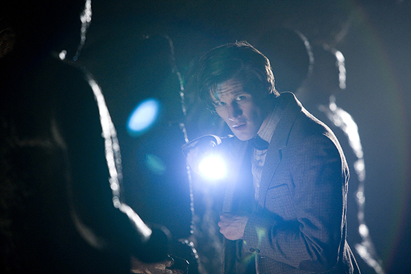 The Doctor (Matt Smith) looking at camera with torch