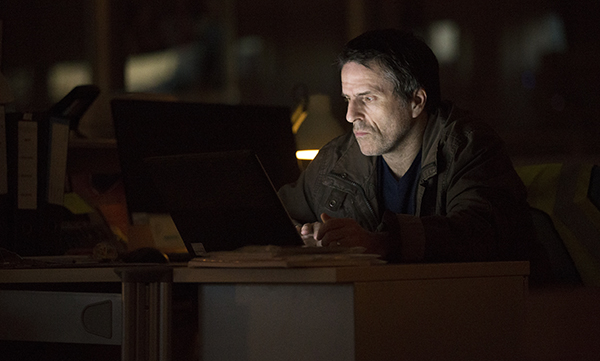 TV series Oridinary Lies - Joe (Con O'Neill) sitting in the dark looking at laptop